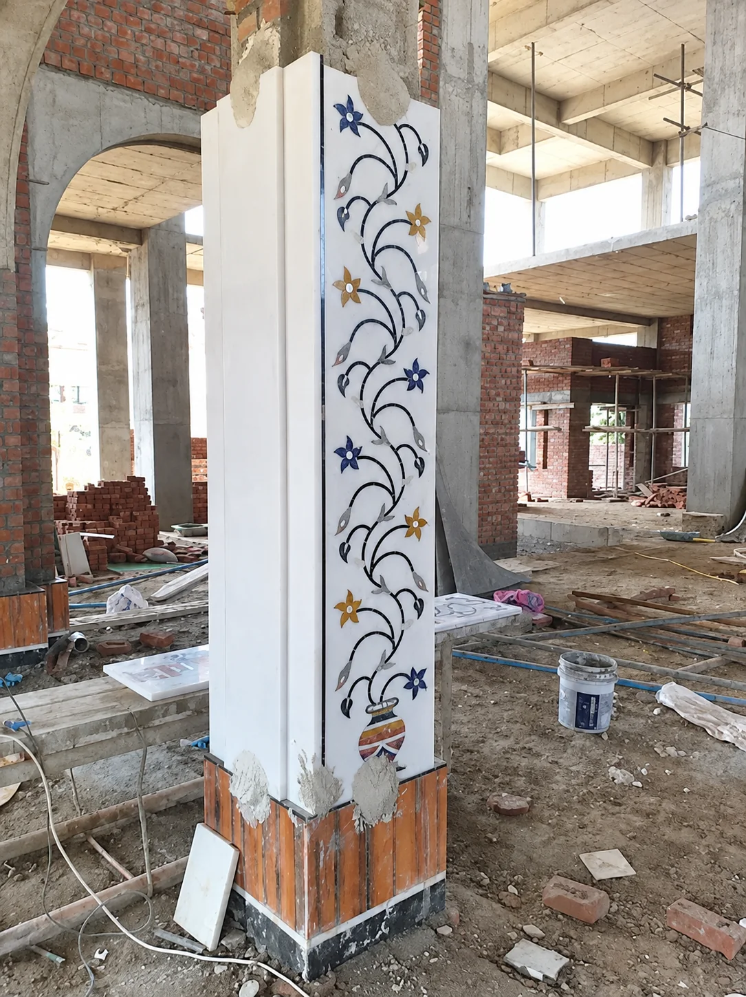 Floral inlaid white marble pillar photographed for Geeta Marble Construction