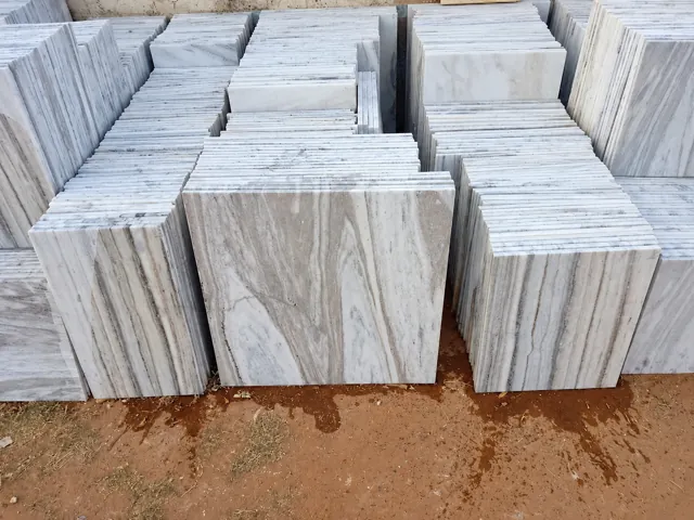 Grey-veined marble tiles stacked for selection — enhanced business photograph