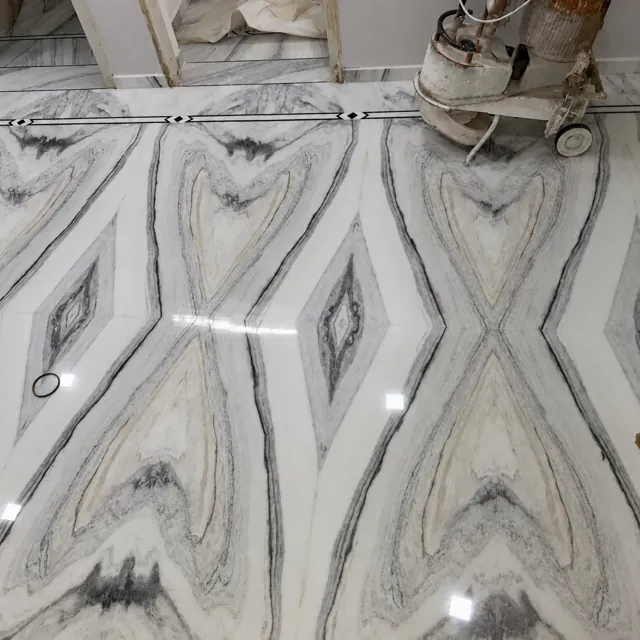 Bookmatched marble floor during finishing — enhanced business photograph