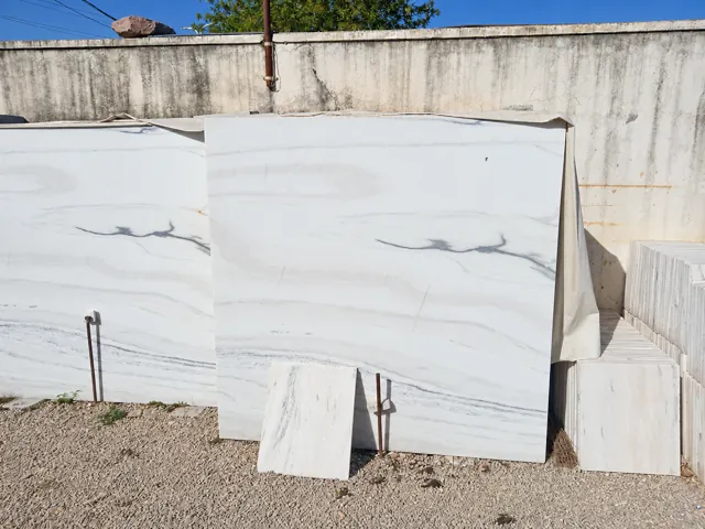 Light marble slab and cut-piece sample — enhanced business photograph