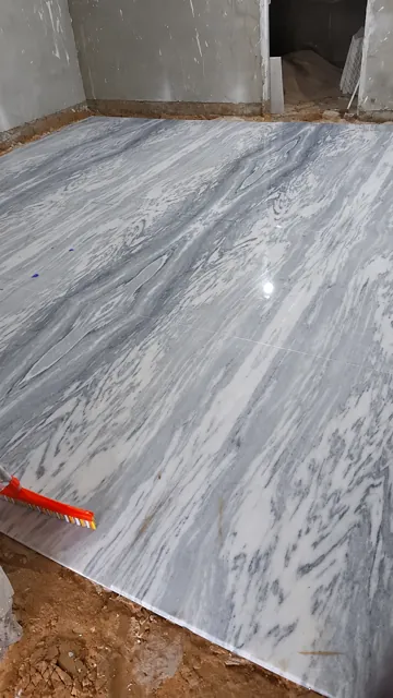 Grey-veined marble floor during installation — enhanced business photograph
