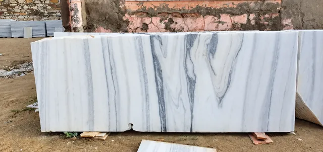 White marble slab with bold grey veining — enhanced business photograph