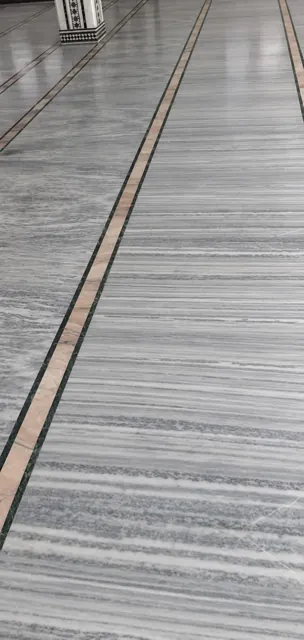 Fitted marble floor with a linear border — enhanced business photograph